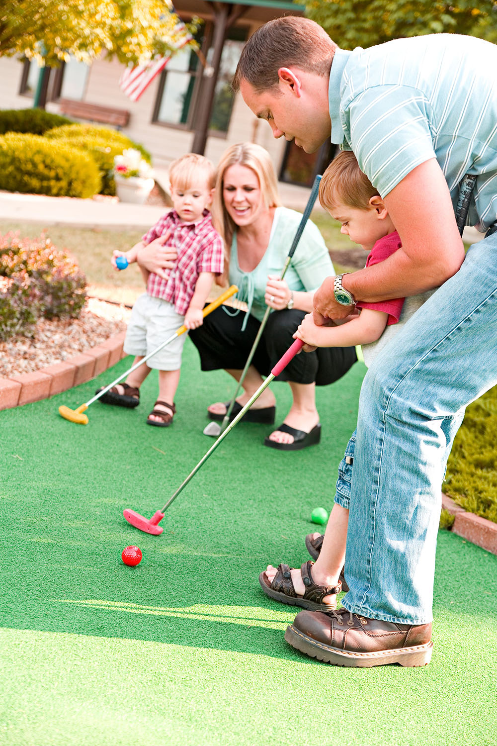 Image of a family playing on a mini golf